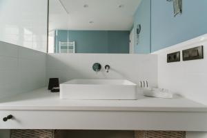 a bathroom with a white sink and a mirror at Modern and luxury- 2Bd 2Bth- Socorro in Seville