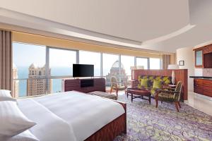 a hotel room with a bed and a large window at Qabila Westbay Hotel by Marriott in Doha