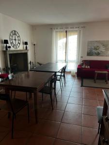a living room with a table and chairs and a couch at Villa Gabry e Villa Fiorita in Camaiore