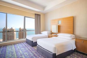 Postelja oz. postelje v sobi nastanitve Qabila Westbay Hotel