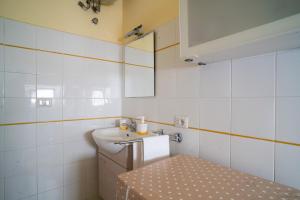 a bathroom with a sink and a toilet and a mirror at Casa Vacanza Giugiò in Giardini Naxos +14 photos