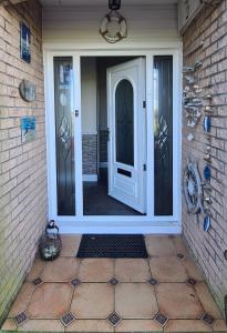 a front door of a home with a white door at Lowefield B&B in Plean