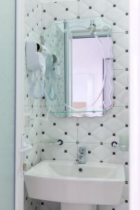 a white bathroom with a sink and a mirror at Guest House Gerard in Ksamil +78 photos