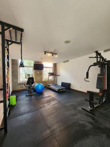 a room with a gym with several tread machines at Howard Johnson Hotel & Resort Funes in Funes
