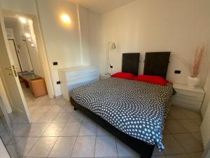 a bedroom with a bed with red pillows on it at Patrizia Apartement in Chioggia