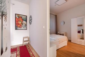 - une chambre blanche avec un lit et un miroir dans l'établissement An der Donau, 10 Minuten ins Zentrum, Klimaanlage, à Vienne