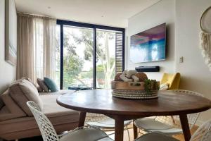 a living room with a table and a couch at Stay and Sea! in Sydney