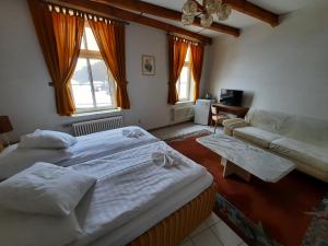 a large bedroom with two beds and a couch at Hotel Koruna in Jeseník