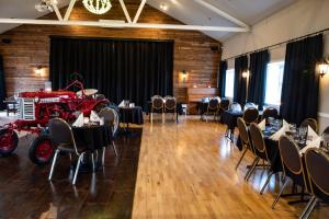 a room with tables and a red fire truck in it at Hótel Fljótshlíd in Hlíðarendi