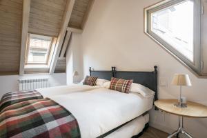 a bedroom with a large bed and a window at Casa Eth Mur by Totiaran in Naut Aran
