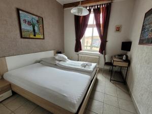 Postel nebo postele na pokoji v ubytování Hotel Koruna