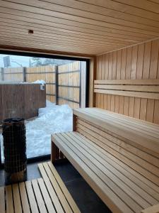 a sauna with a bench and snow outside of it at Apartament Morskie Oko Odkryj Zakopane in Zakopane