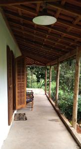 a covered porch of a house with a wooden ceiling at Recanto Águas Claras in Soledade de Minas