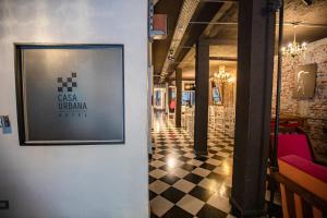 a room with a picture on the wall and a checkered floor at Casa Urbana Hotel in Córdoba