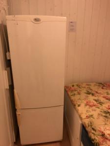 a white refrigerator in a room with a bed at Almenningsgata 9A in Stavanger