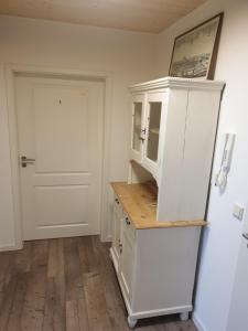 a kitchen with a white cabinet and a door at Gästehaus Stüpfert Grüber Stein in Grub am Forst