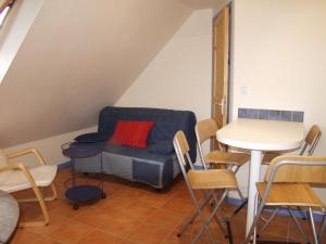 a room with a couch and a table and chairs at Appartement Le Palais, 2 pièces, 2 personnes - FR-1-418-165 in Le Palais