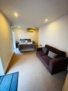 a living room with a bed and a couch at Modern&Large 3bed 3Bath Central London Air-Con Hyde Park in London