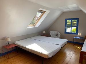 a bedroom with a bed and a window at Maison Locmaria, 2 pièces, 4 personnes - FR-1-418-163 in Locmaria