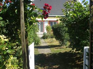 a garden with a pathway leading to a house at Appartement Le Palais, 2 pièces, 3 personnes - FR-1-418-171 in Le Palais