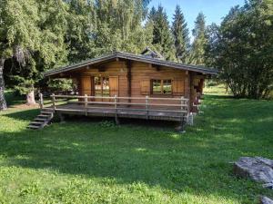 a log cabin in a field of green grass at Chalet Megève, 3 pièces, 4 personnes - FR-1-453-255 in Megève