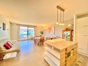 a living room with a couch and a table at F3 lumineux avec terrasse, parking et WiFi à Veyrier-du-Lac - FR-1-432-81 in Veyrier-du-Lac