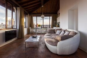 a living room with a white couch and a table at L'Altana City House in Brescia