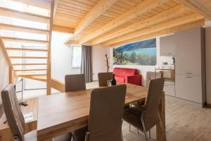 a kitchen and dining room with a wooden table and chairs at Residenza al Castello in Enguiso