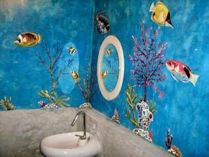 a bathroom with a sink and fish painted on the wall at The Colored House Jomtien in Jomtien Beach