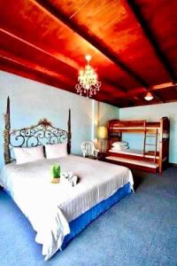 a bedroom with a large bed with a red ceiling at The Colored House Jomtien in Jomtien Beach