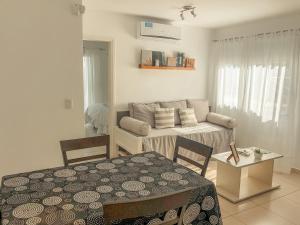 a living room with a table and a couch at Good Life Resort in La Falda