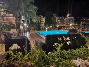 a view of a swimming pool at night at SunLake Hotel in Riva del Garda