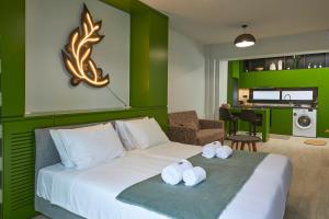 a hotel room with a bed with towels on it at Olea Apartments in Thessaloniki