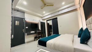 a bedroom with a large bed and a bathroom at Hotel Baba Deluxe -By RCG Hotels in New Delhi