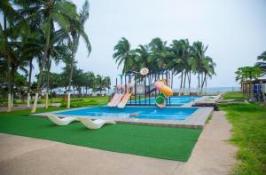 a childrens playground with a slide and a play equipment at Hotel Riviera Ramatou Plage in Lomé