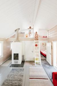 a room with two bunk beds and a fireplace at Pikku Torppa Cottage in Kotka