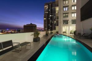 a swimming pool on the roof of a building at Luxury two-beds harbour views apartment in Darwin