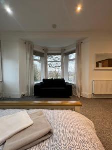 a living room with a couch and a bed at Town House A in West House Mews in Dunston