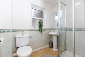 a bathroom with a toilet and a sink and a shower at In the heart of it! in Stokesley