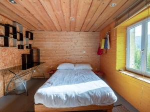 a bedroom with a bed in a wooden room at La Maison de Max - avec terrasse in Saulxures-sur-Moselotte