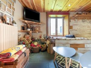 a living room with a couch and a table at La Maison de Max - avec terrasse in Saulxures-sur-Moselotte
