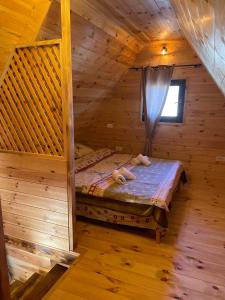 a bedroom in a log cabin with a bed at Family home MASA in Žabljak