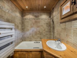 a bathroom with a sink and a bath tub at Chalet Megève, 5 pièces, 8 personnes - FR-1-453-12 in Megève