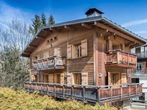 a large wooden house with balconies on a hill at Chalet Megève, 5 pièces, 8 personnes - FR-1-453-12 in Megève