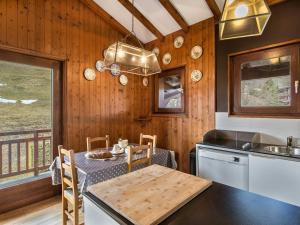 a kitchen with a table and a dining room at Confortable 3 pièces avec animaux admis à Megève Jaillet - FR-1-453-38 in Megève