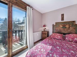 a bedroom with a bed and a large window at Appartement Megève, 3 pièces, 4 personnes - FR-1-453-48 in Megève