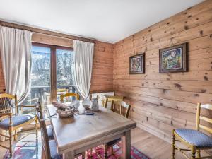 a dining room with wooden walls and a table and chairs at Appartement Megève, 3 pièces, 4 personnes - FR-1-453-48 in Megève