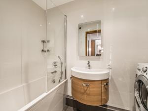 a bathroom with a sink and a shower and a washing machine at Appartement 3 pièces au centre de Megève, balcon, proche télécabine, Wifi, idéal pour 4 personnes - FR-1-453-53 in Megève