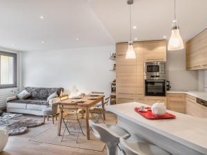 a kitchen and living room with a table and chairs at Appartement 3 pièces au centre de Megève, balcon, proche télécabine, Wifi, idéal pour 4 personnes - FR-1-453-53 in Megève