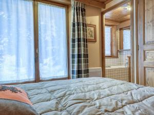 a bedroom with a bed and a large window at Appartement Megève, 2 pièces, 4 personnes - FR-1-453-105 in Megève